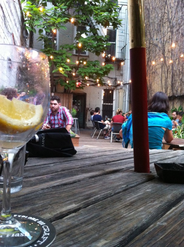 White lights in a garden full of relaxed, summery people.