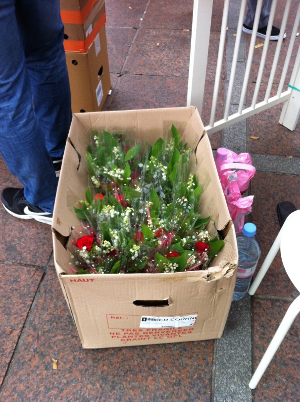 Boxes of flowers, muguet to surely spare. 
